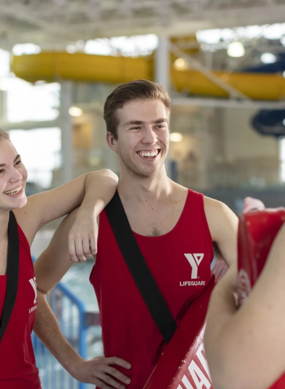 Lifeguards at the pool smiling