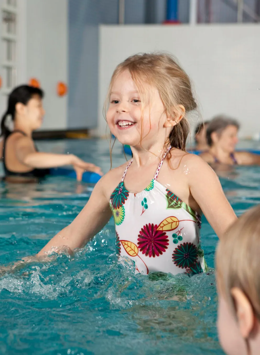 Young girl learning to swim