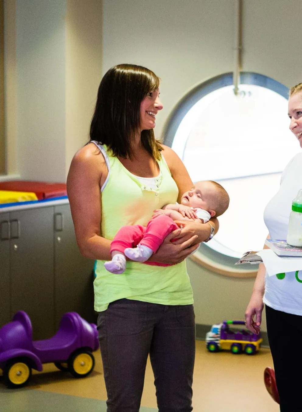mom, baby and friend in child play area