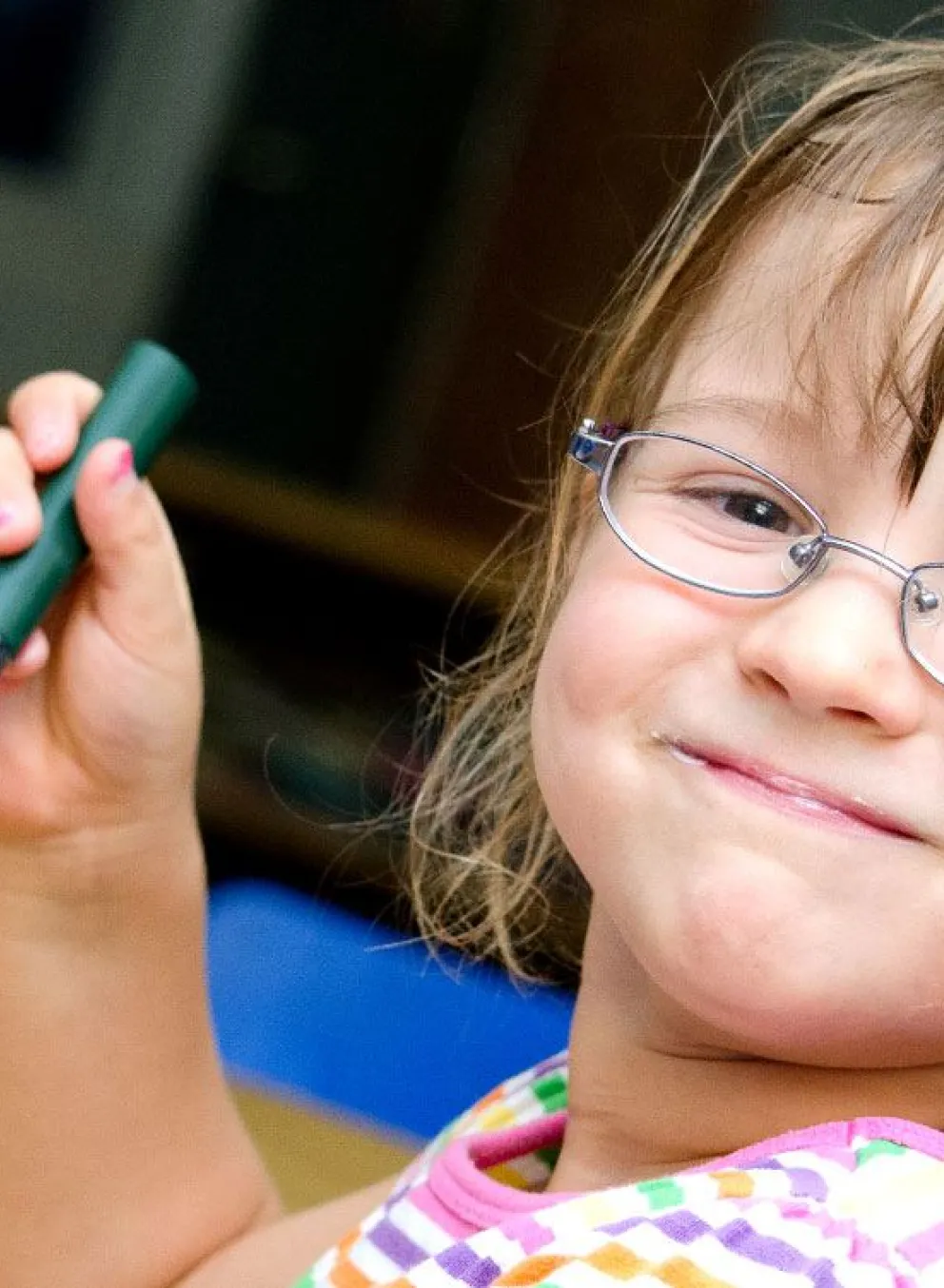 child with glasses eats yogurt and carrots