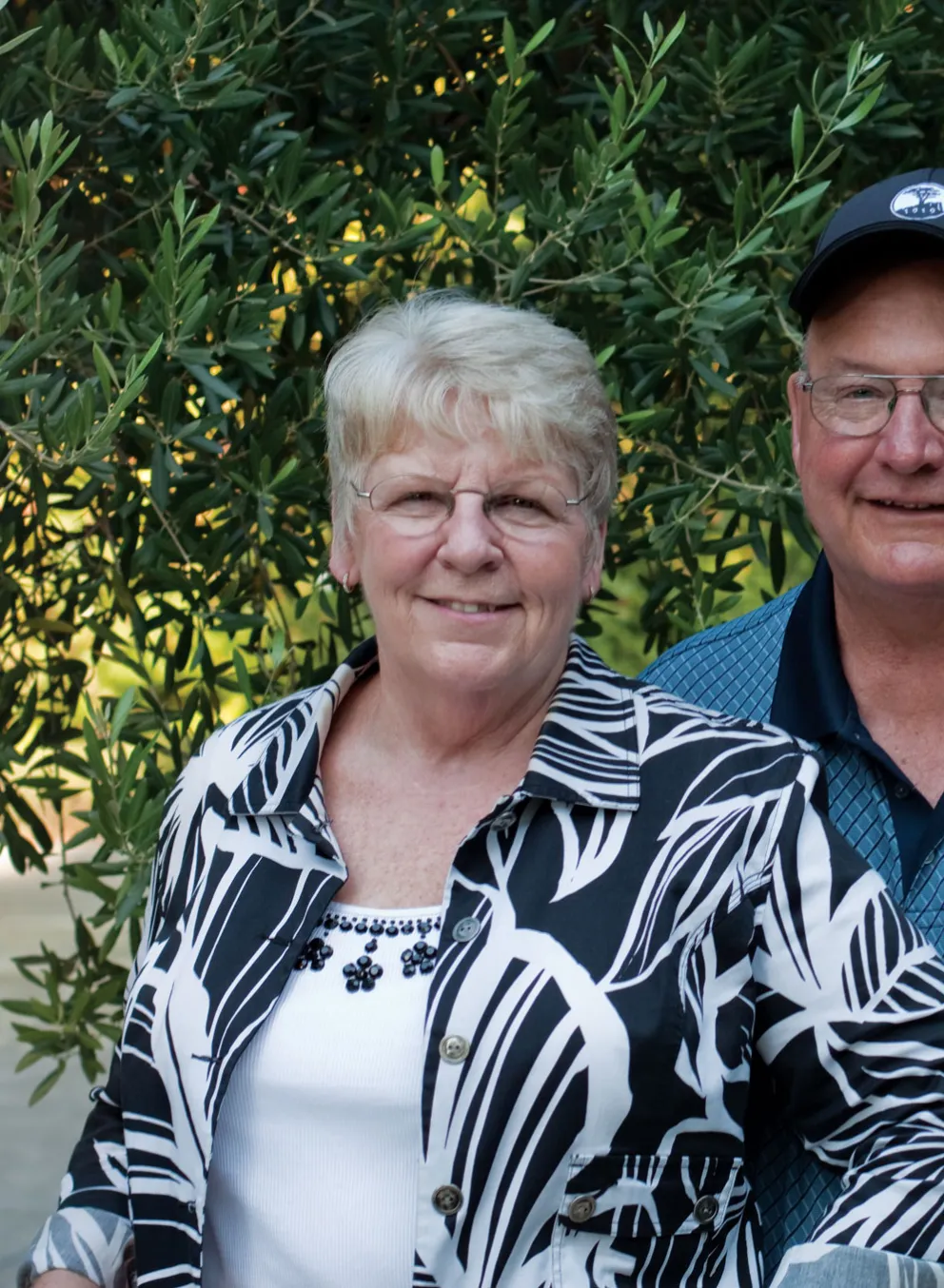 two seniors smiling at camera
