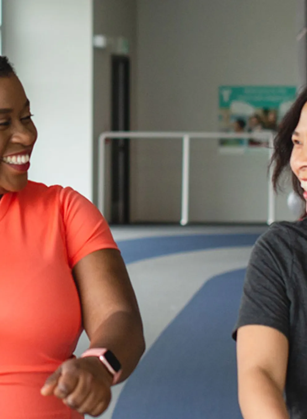 Coach and participant happily using walking track together