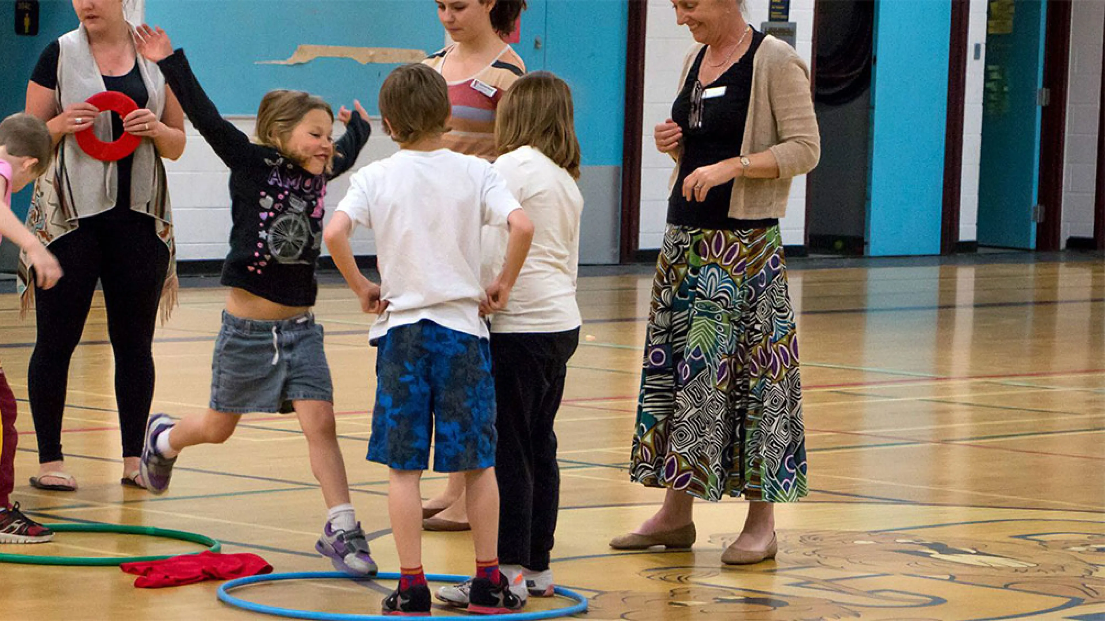 kids playing game with hula hoops and rings