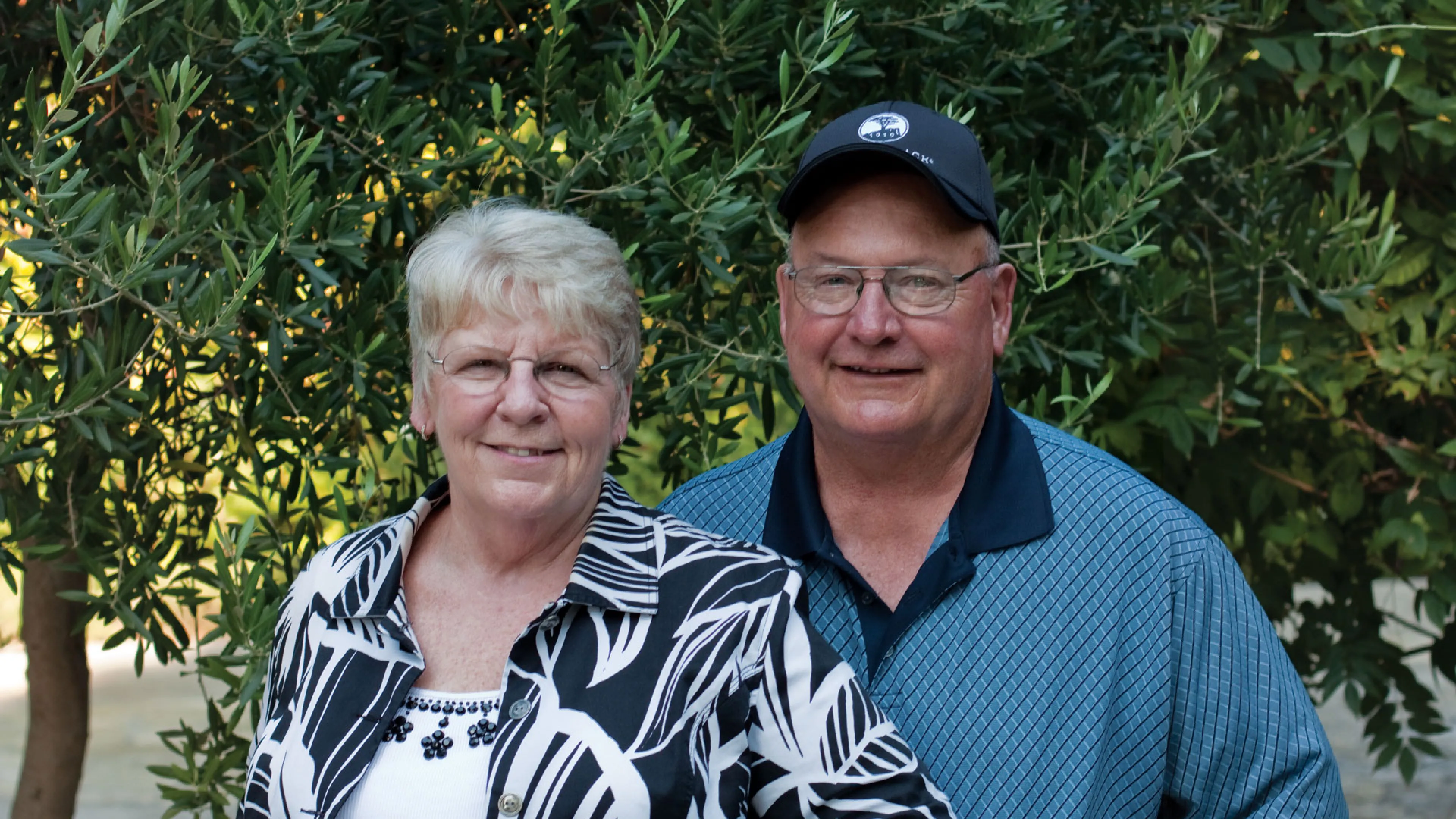 two seniors smiling at camera