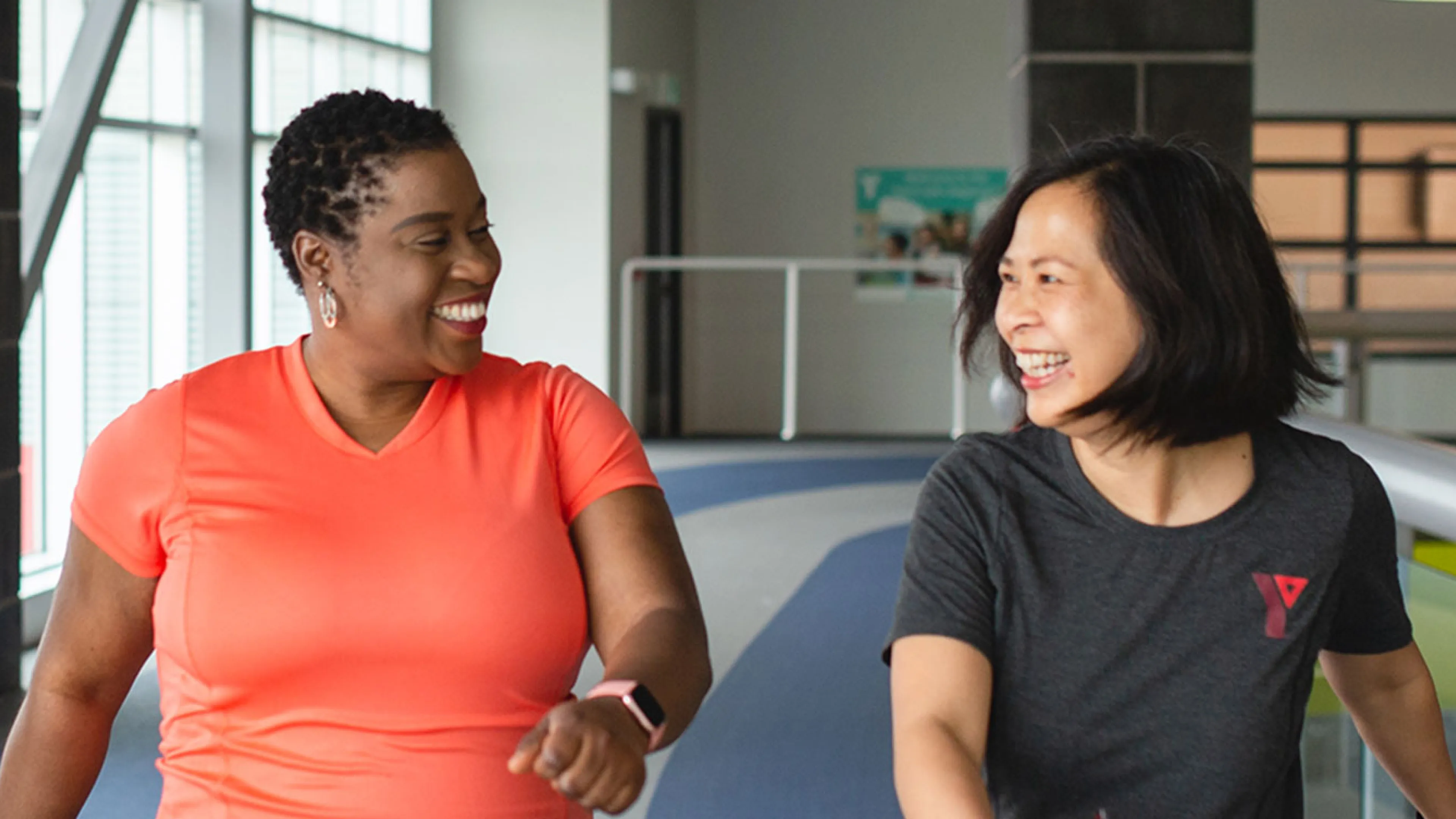 Coach and participant happily using walking track together